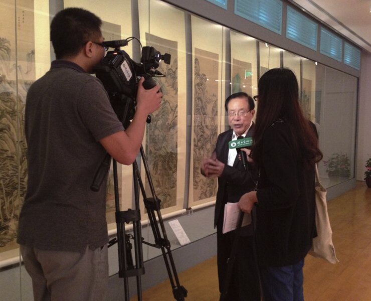 北京故宮研究員單國強接受媒體訪問，後方作品為王鑑所畫的〈仿古山水圖〉12屏，上海博物館藏。