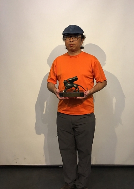 手捧威尼斯金獅獎的黃心健。攝影:林亞偉