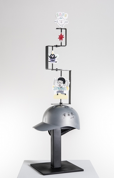 插畫：黑眼包／設計：黑眼包xRM S tudio／鐵作：劉寧益《Untitled Helmet》．不鏽鋼、發泡板．25x30x95 cm．2017。圖片提供：富邦藝術基金會
