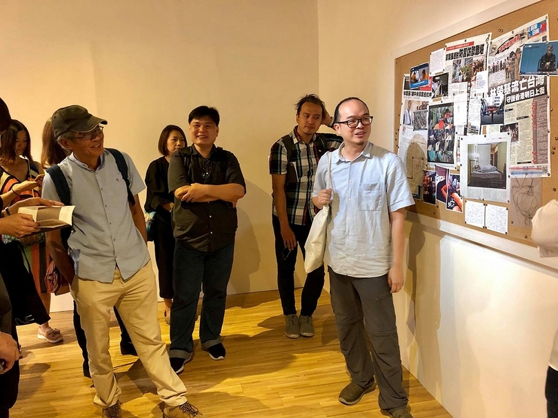 「Chris Evans、白雙全:雙個展」展覽開幕時,藝術家白雙全(右)為現場觀眾導覽,而左方戴帽者為林榮基。(鄭慧華提供)