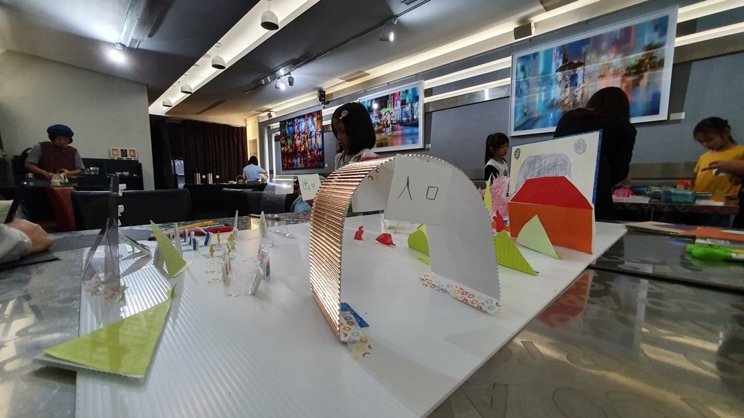 「娛樂時代——記沒有電視的十年」兒童策展工作坊五個半天的工作營與一場紙上模型展，三組兒童截然不同的娛樂生活想像躍於A1大的紙張上，有集結童話的故事森林開放式展覽、有迷宮動線貫穿的郊遊展、也有媲美美術館白盒子的畫展。（胡忻儀提供）