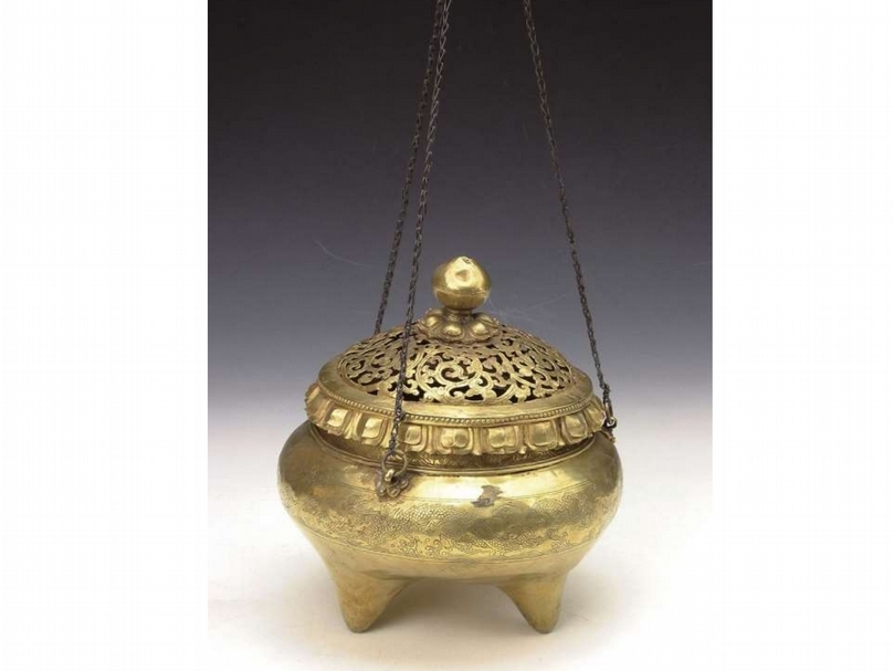 清《金提爐》 佛教寺廟供奉法器用具。此件提爐高20公分，圓桶形護身，帶鏤空八卦紋傘形蓋，圓形蓋鈕。三鏤空夔龍銜環耳、三象首足、三條金鏈。（劉曉晨提供）