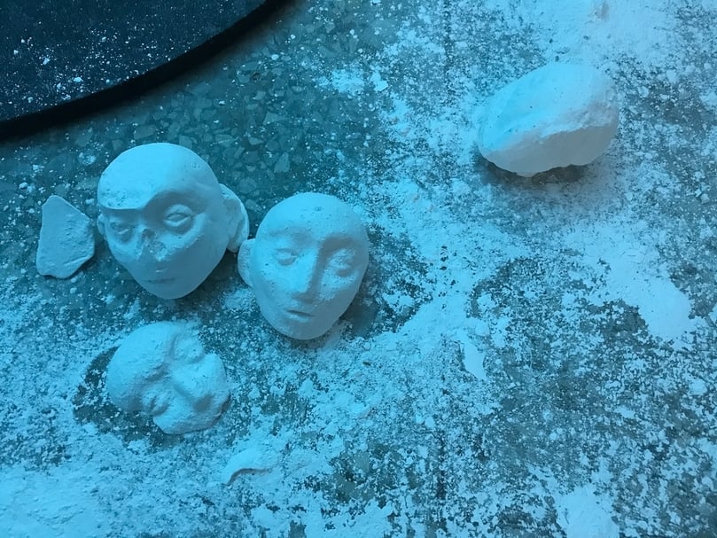 《白色訓導—複耗的公轉》中於地上碎裂的人頭,象徵被國家機器消磨的政治犯。(攝影/陳飛豪)