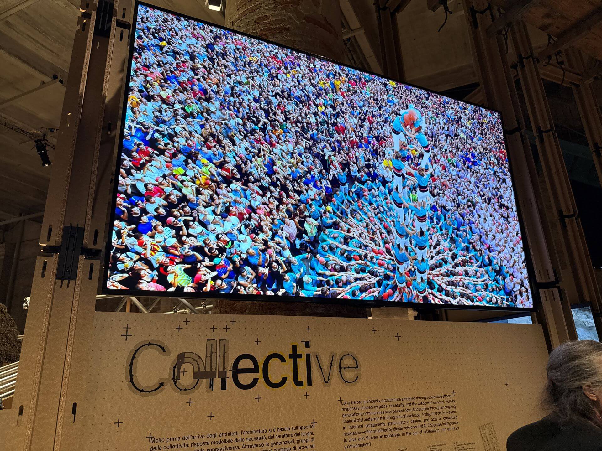 「集體智慧」（Collective）展區風景，螢幕正播放西班牙「疊人塔」民俗節慶活動。（攝影／朱佑霖）