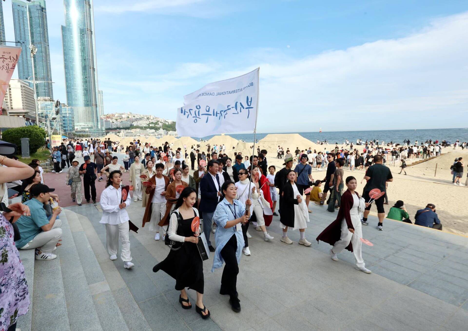 在海雲台海灘節目開演前，從面海的市街上開始遊街，讓舞者定點表演，吸引遊客跟著隊伍一起前進到海灘表演台。（釜山國際舞蹈節提供）