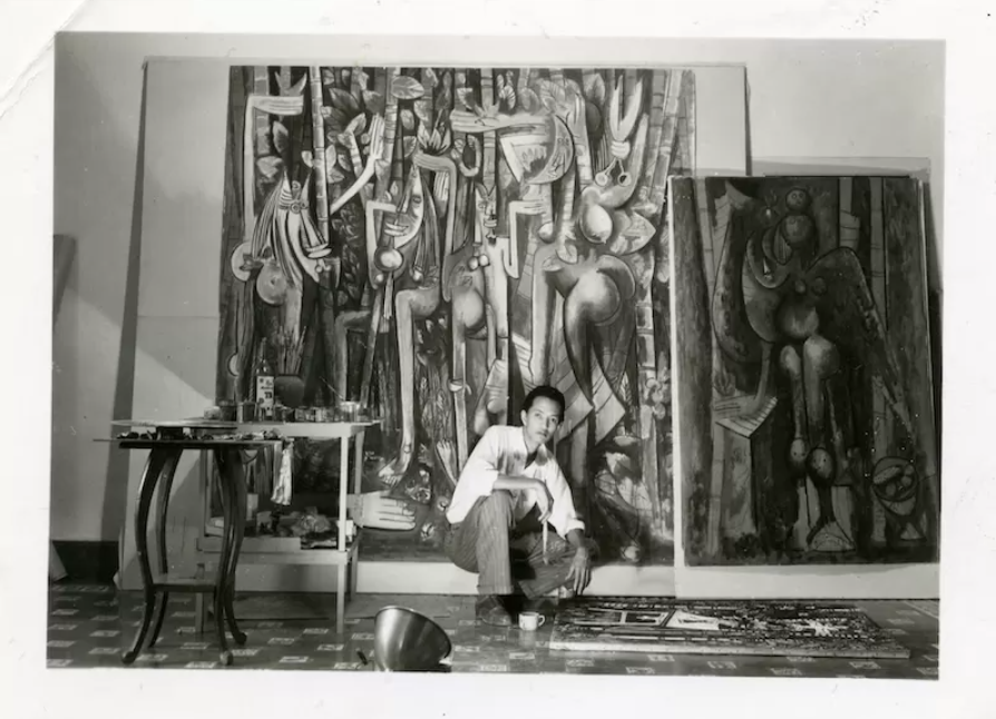 林飛龍於其哈瓦那工作室（1943 年）；與《叢林》（1942–43）、《綠色的早晨》（1943），以及地面上的《椅子》（1943）。（Archives SDO Wifredo Lam）