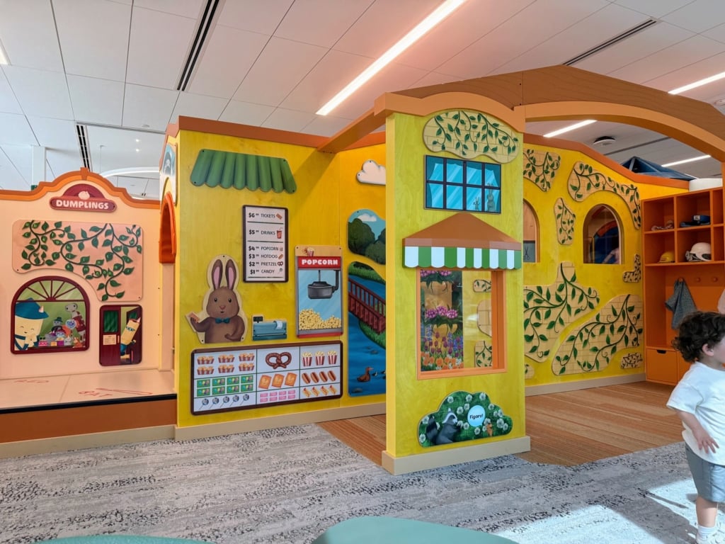 SCCLD 之 Campbell Library 的主題是夢幻街區(Dreamy Downtown),由於圖書館就位於市中心,遊戲場將附近的農夫市集、水塔地標、街道商家融入設計,孩子可以套上扮演服裝,穿梭在迷你城市的餐館、電影院和商店,和照…